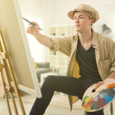 Teen boy painting small